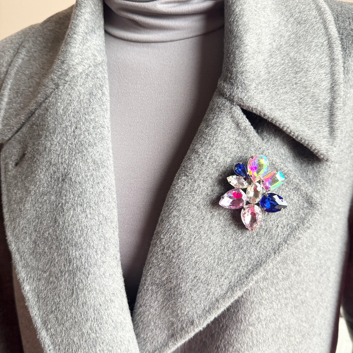 Crystal flower brooch Sonata worn on a coat with vivid multicolor sparkle