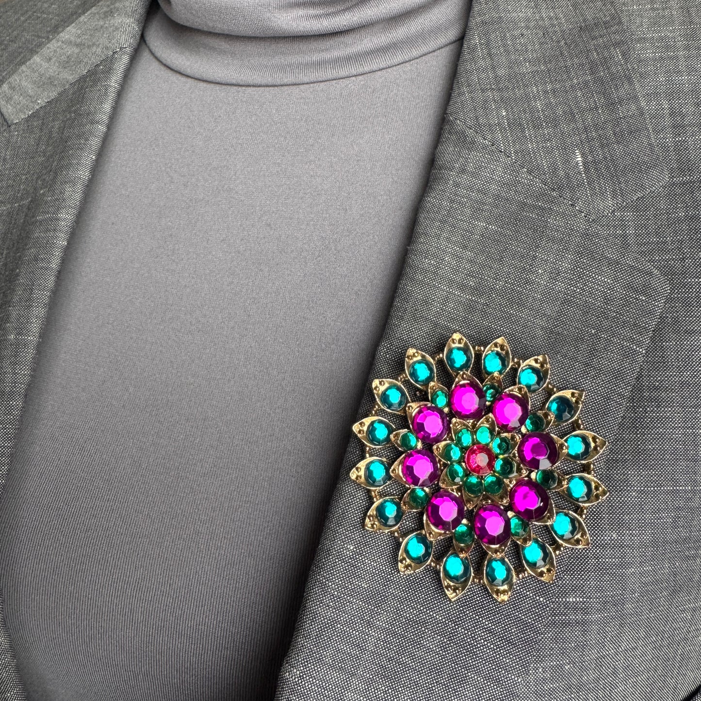 Colorful crystal brooch Sonata worn on a blazer with a radiant geometric arrangement