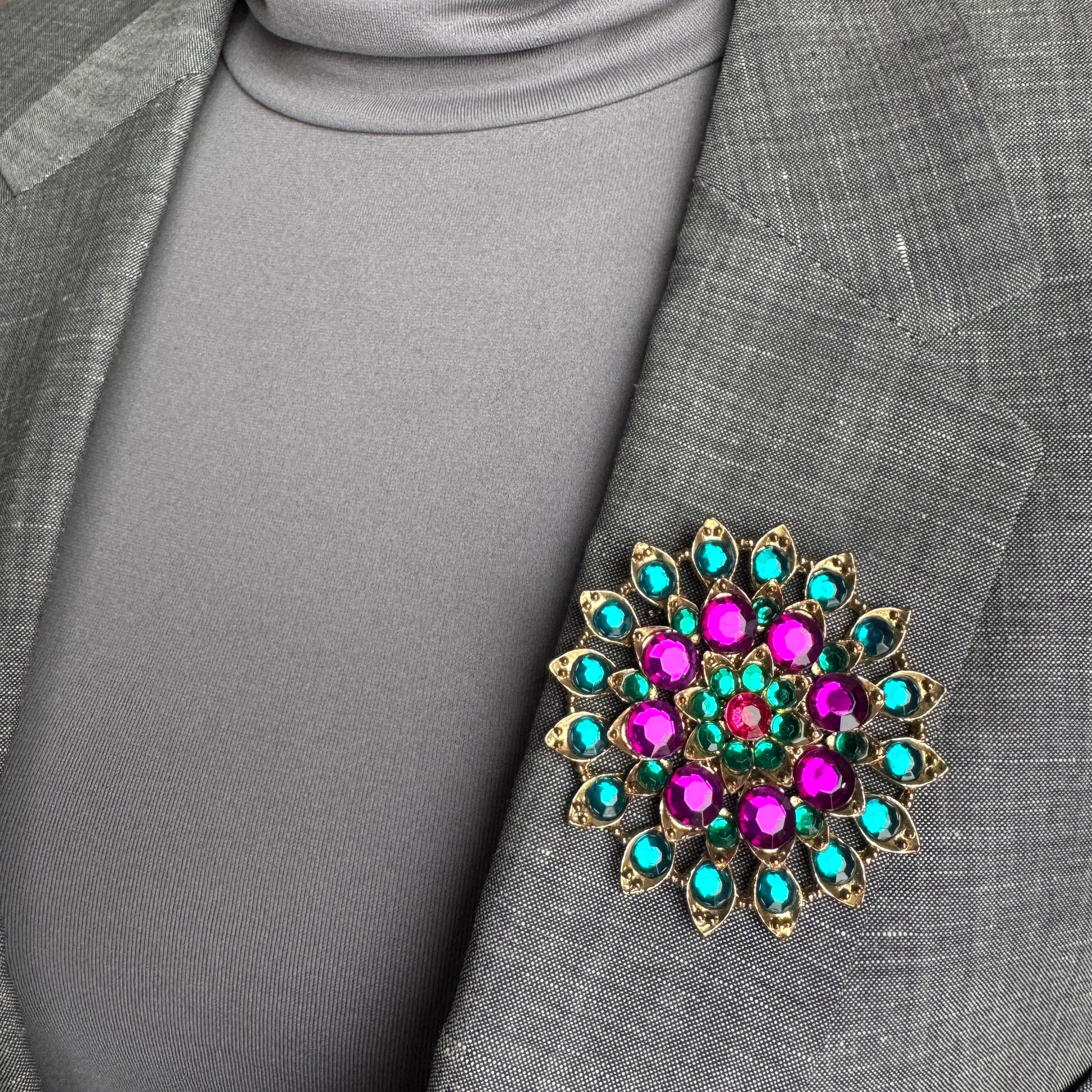Colorful crystal brooch Sonata worn on a blazer with a radiant geometric arrangement
