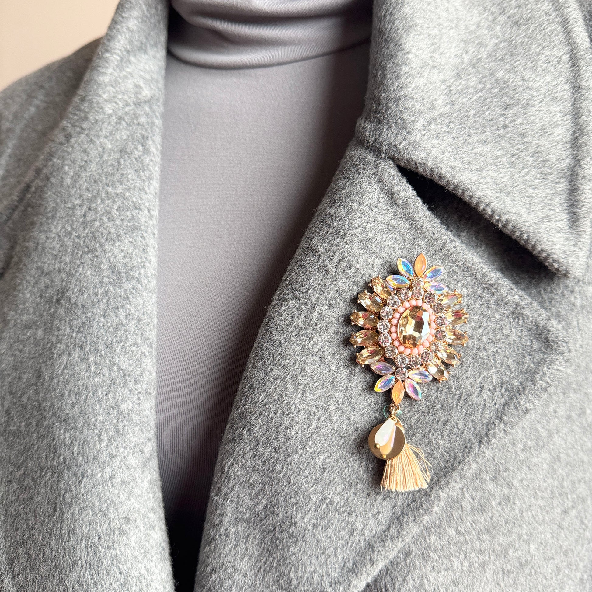 Crystal flower brooch Sonata worn on a blazer with a soft tassel detail