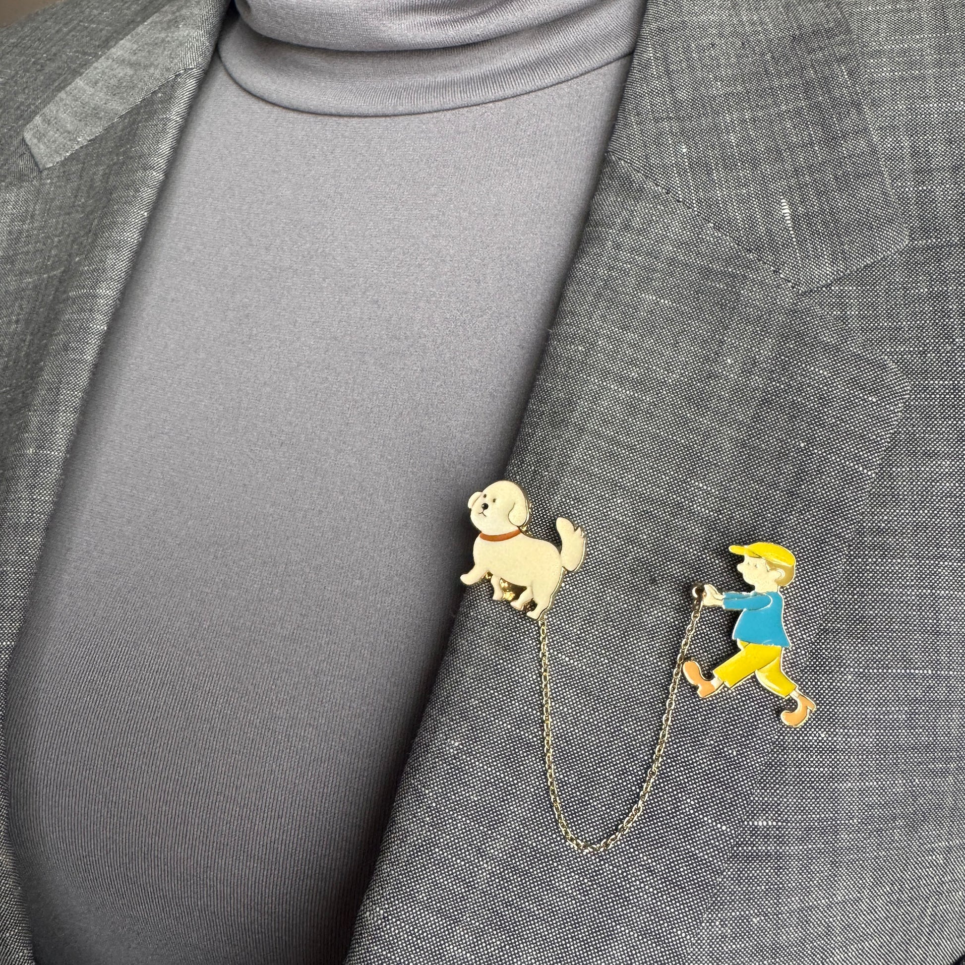 Double pin brooch Sonata worn on a blazer with a boy and dog motif