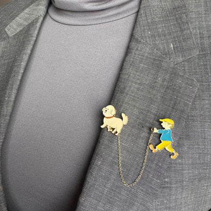 Double pin brooch Sonata worn on a blazer with a boy and dog motif