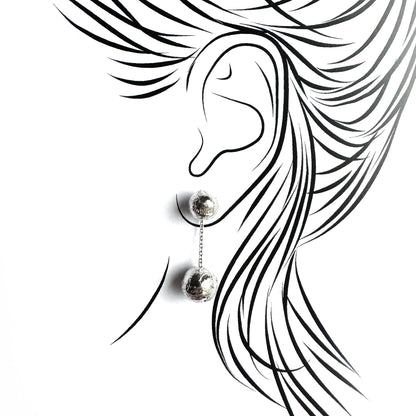 Ball drop earrings shown on an ear outline for a light, elegant silhouette