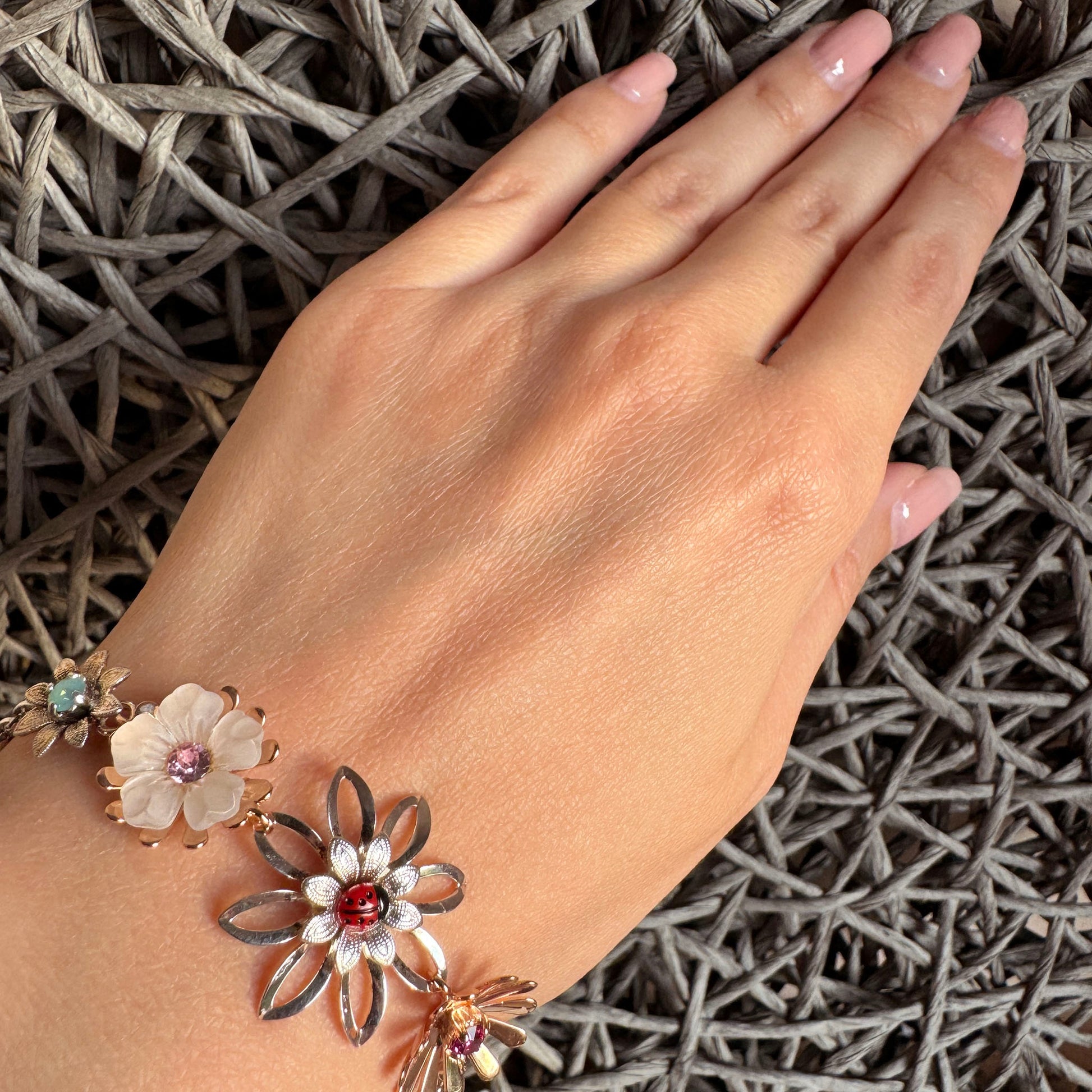 Handmade Reminiscence bracelet with floral charms and ladybug accent for elegant outfits