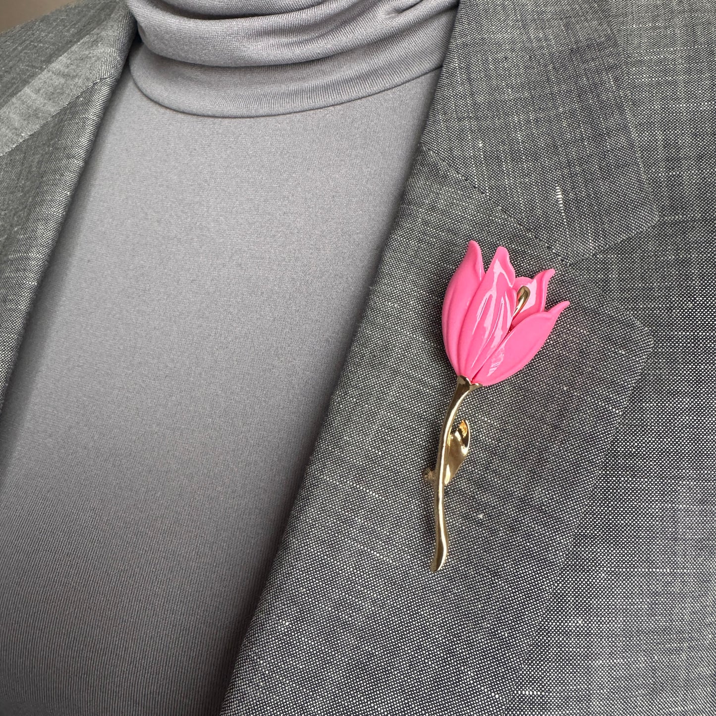 Pink flower brooch Sonata worn on a blazer with a slender curved stem