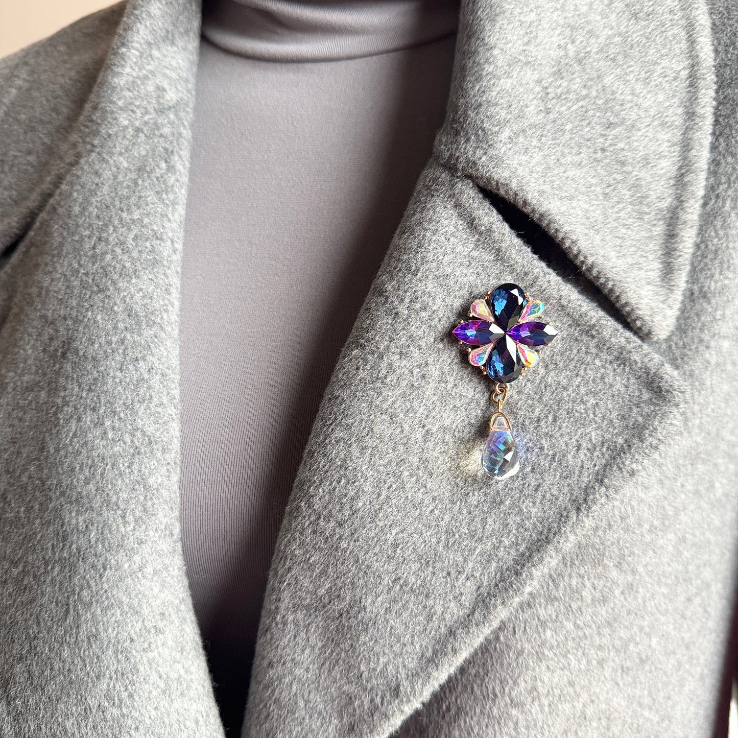 Crystal flower brooch Sonata worn on a coat with a light-catching drop