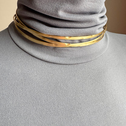 Multi-band gold choker Pilgrim worn on the neck with a clean sculptural look