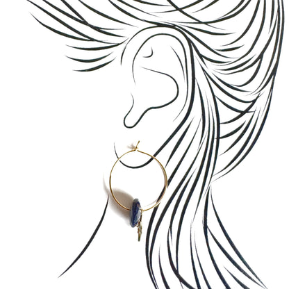 Gold IRL hoop earrings with midnight blue stone and star charm on ear illustration