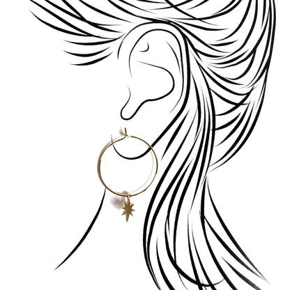 Gold hoop earrings with delicate star charm and polished surface shine