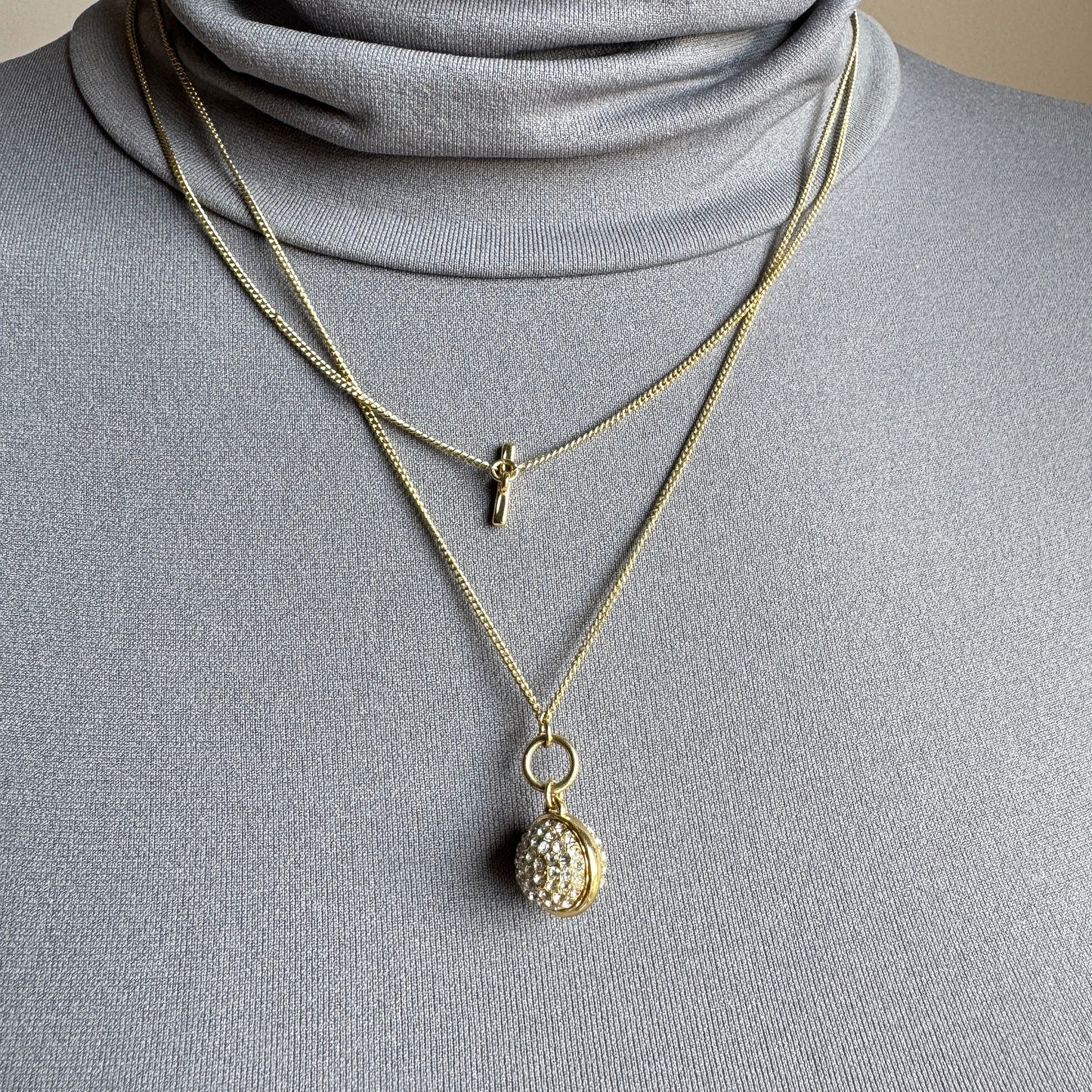 Gold Pilgrim necklace with sparkling sphere pendant worn layered