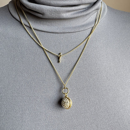 Gold Pilgrim necklace with sparkling sphere pendant worn layered