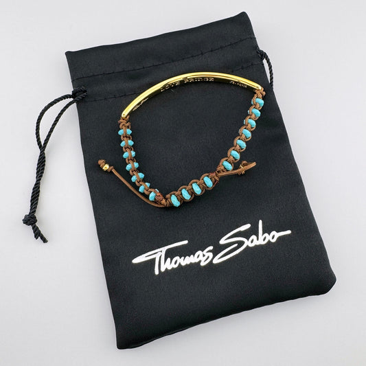 Pozłacana bransoletka Love Bridge Thomas Sabo z turkusem na czarnym firmowym woreczku