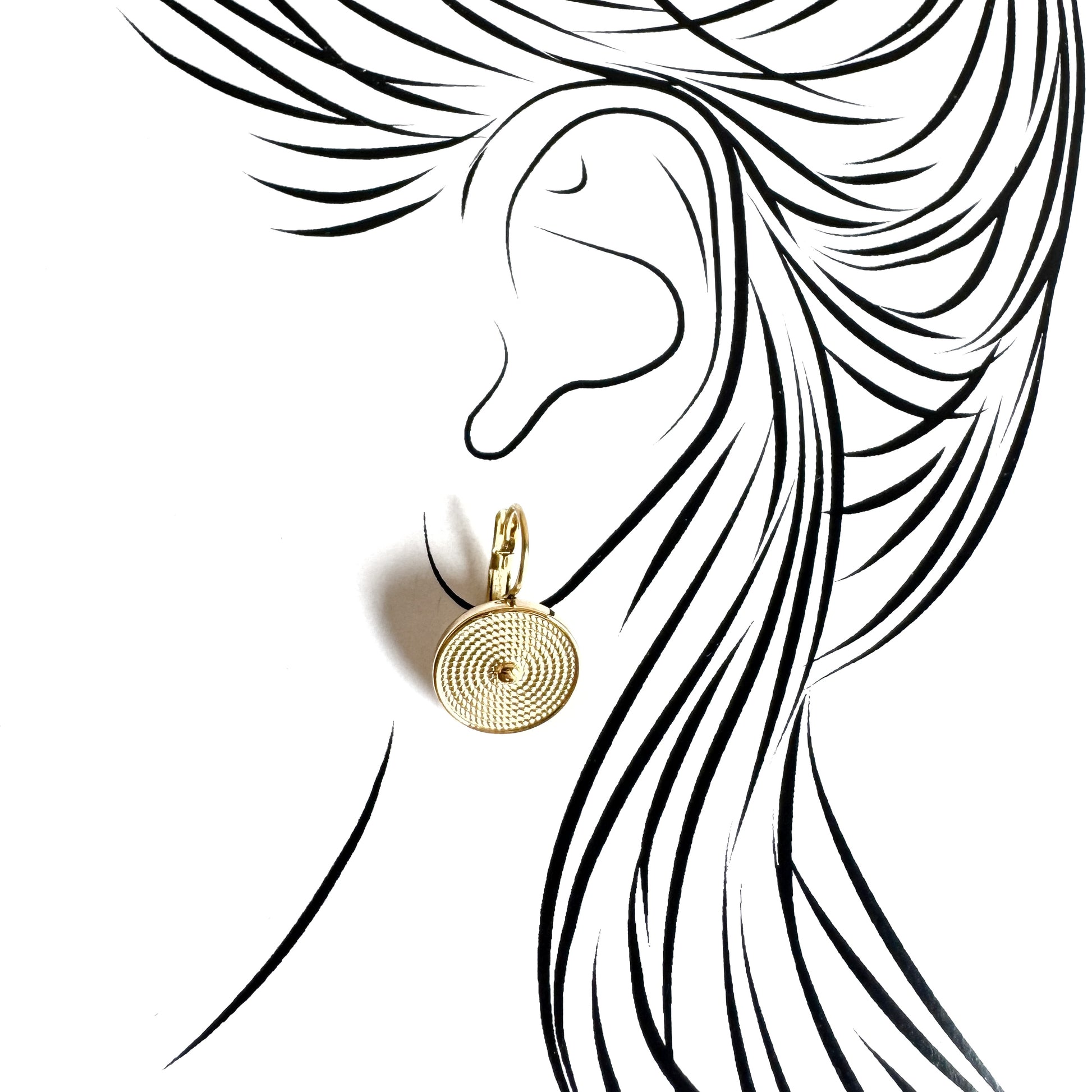 Gold hoop earrings with spiral medallions worn on the ear