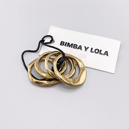 Gold-tone Bimba y Lola ring set with sculptural organic bands and branded tag