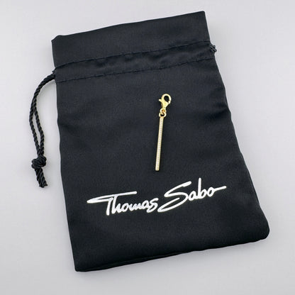 Złocony charms Thomas Sabo z cyrkoniami i firmowym czarnym woreczkiem