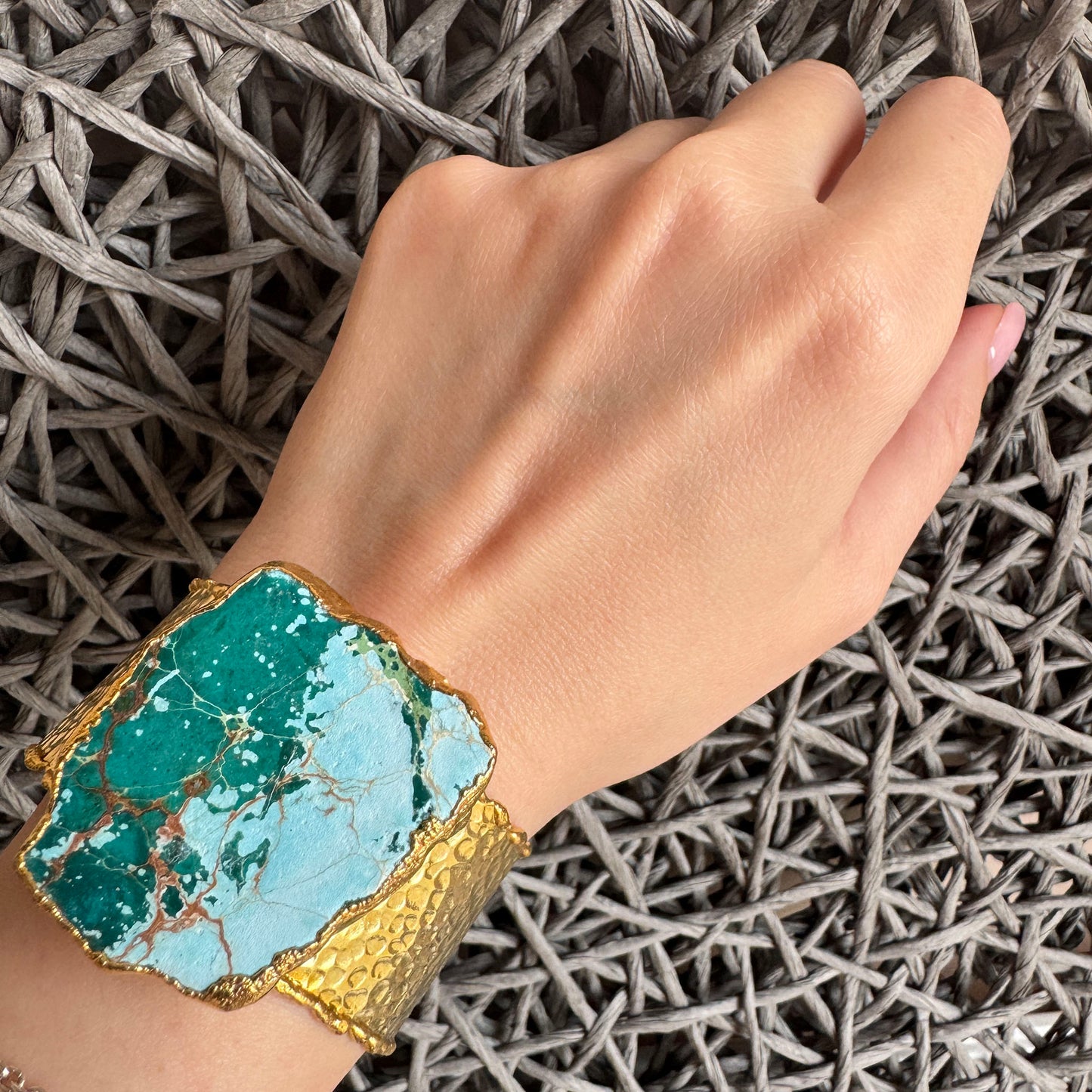 Wide gold-plated cuff bracelet with natural turquoise stone and textured finish