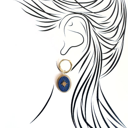 Asymmetrical gold earrings with blue lapis lazuli pendant on one side