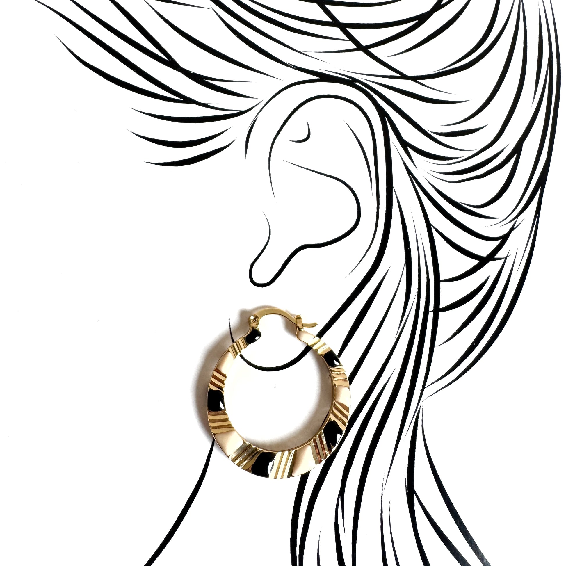 Golden hoop earrings with black and cream enamel, geometric design emphasizing modern elegance and bold style