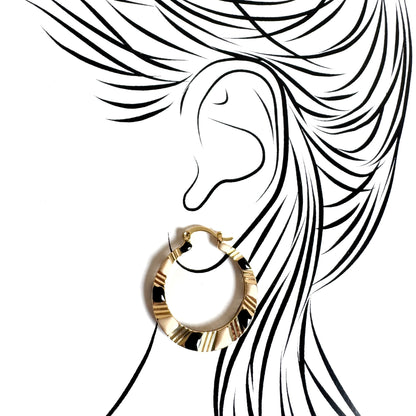 Golden hoop earrings with black and cream enamel, geometric design emphasizing modern elegance and bold style