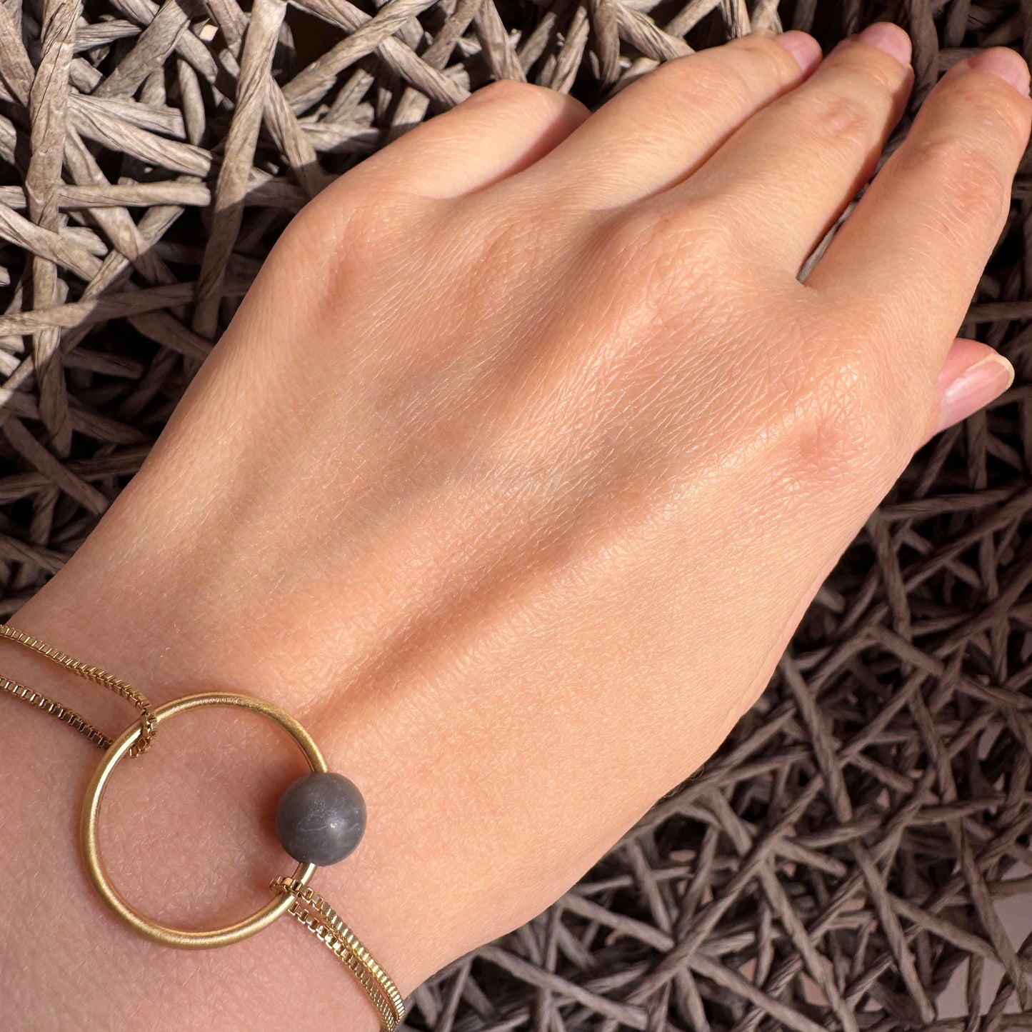 Natural grey stone bracelet on the wrist, elegant and calm for everyday wear