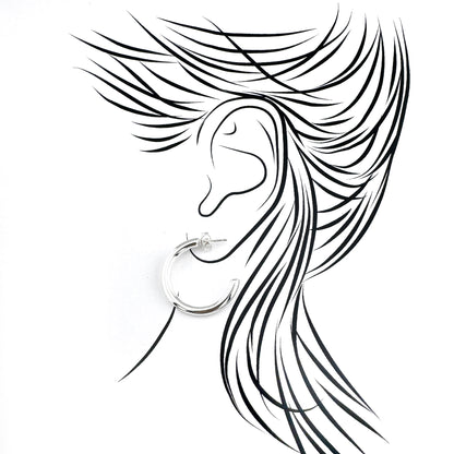 Polished half-hoop earrings in plated stainless steel, clean curves catching light with a modern minimalist mood