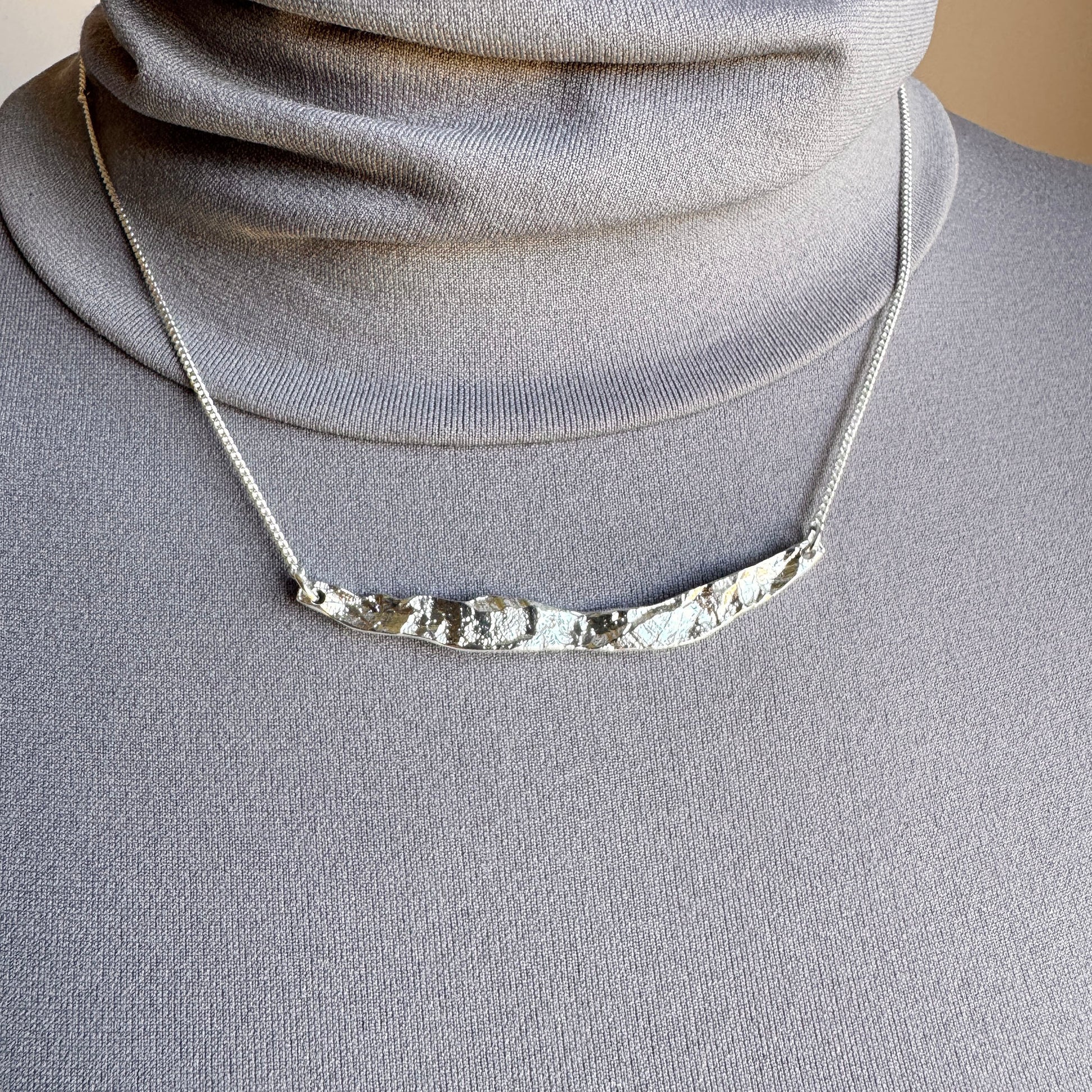 Elegant silver necklace with organic hammered texture and adjustable chain