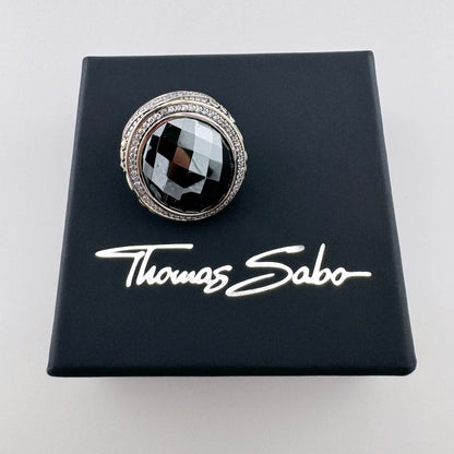 Silver Thomas Sabo ring with a faceted hematite displayed on a branded black box