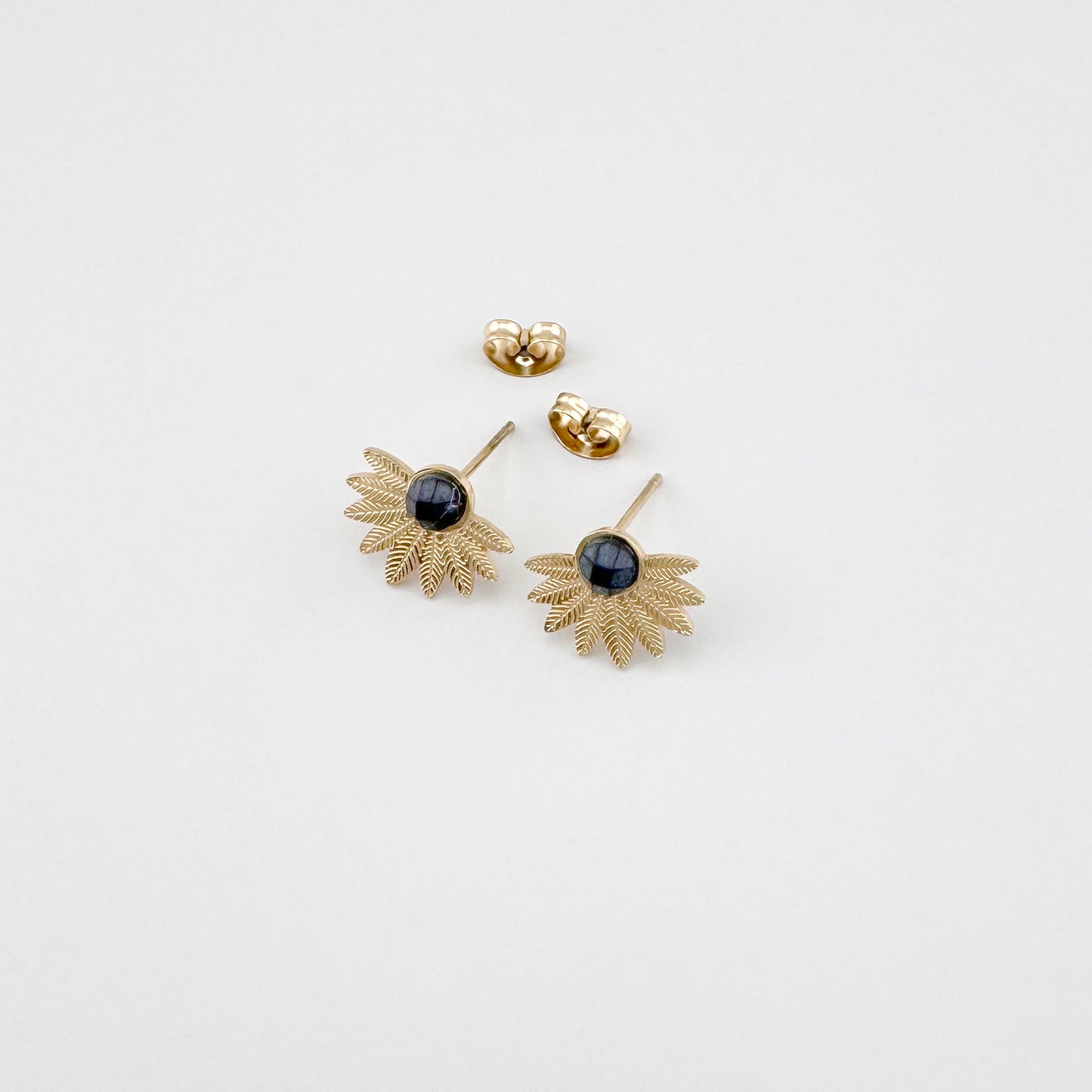 Gold-tone agate earrings showing stud fastening and texture