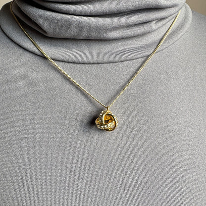 Elegant Pilgrim necklace with knot-shaped pendant and sparkling zirconia stones
