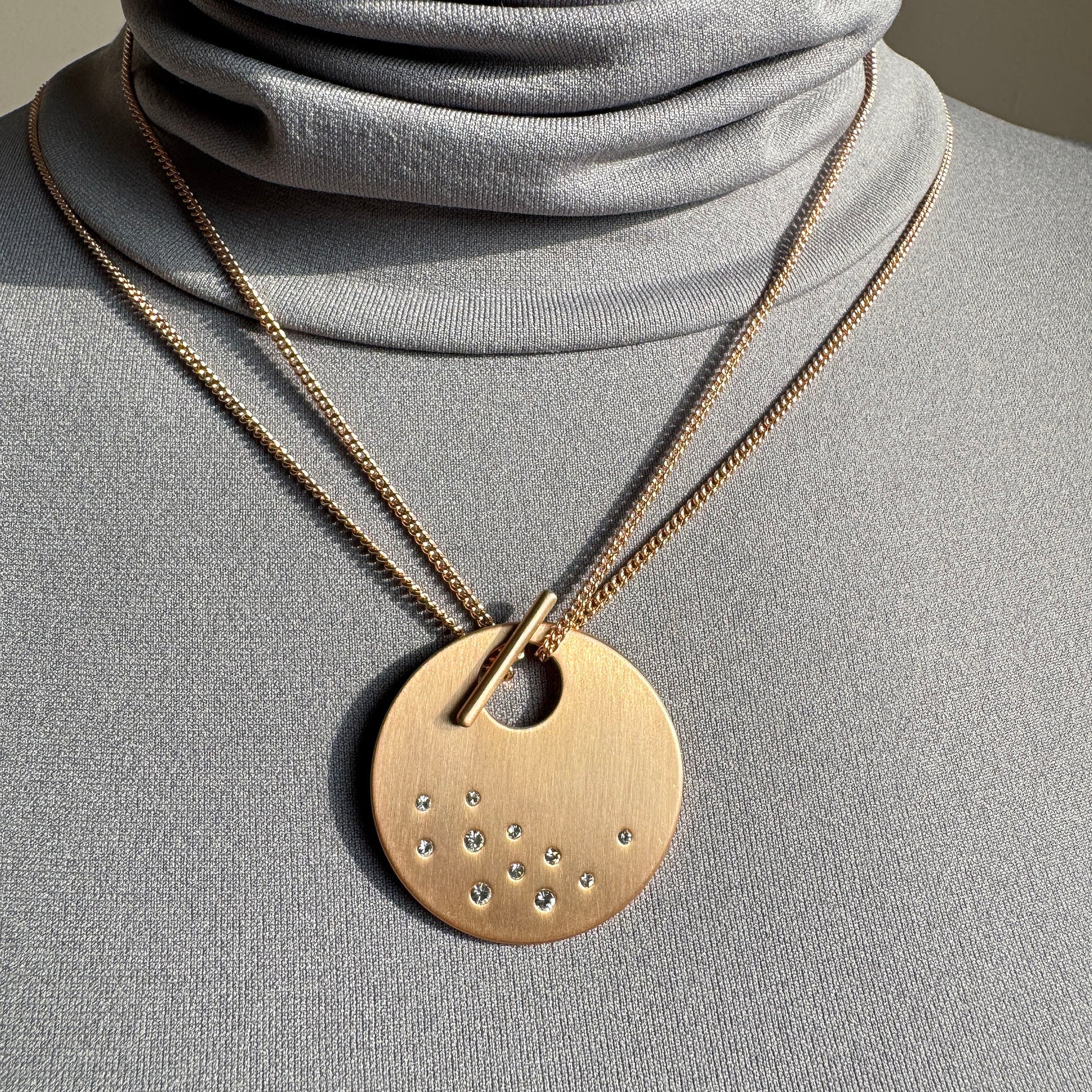 Elegant Pilgrim necklace with large round medallion disc and subtle zircon details