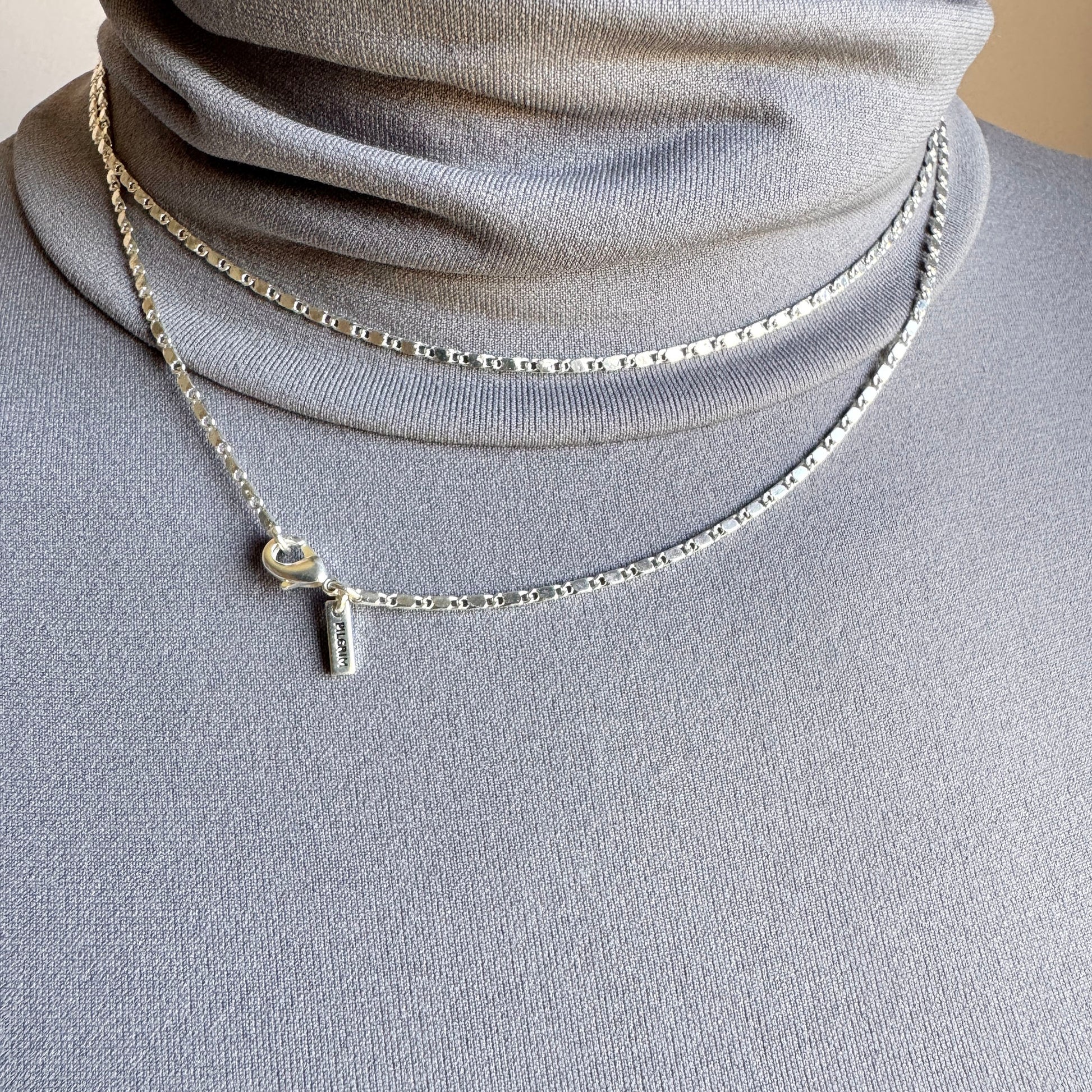 Silver minimalist chain necklace with geometric details and adjustable clasp