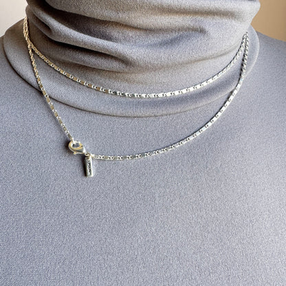 Silver minimalist chain necklace with geometric details and adjustable clasp