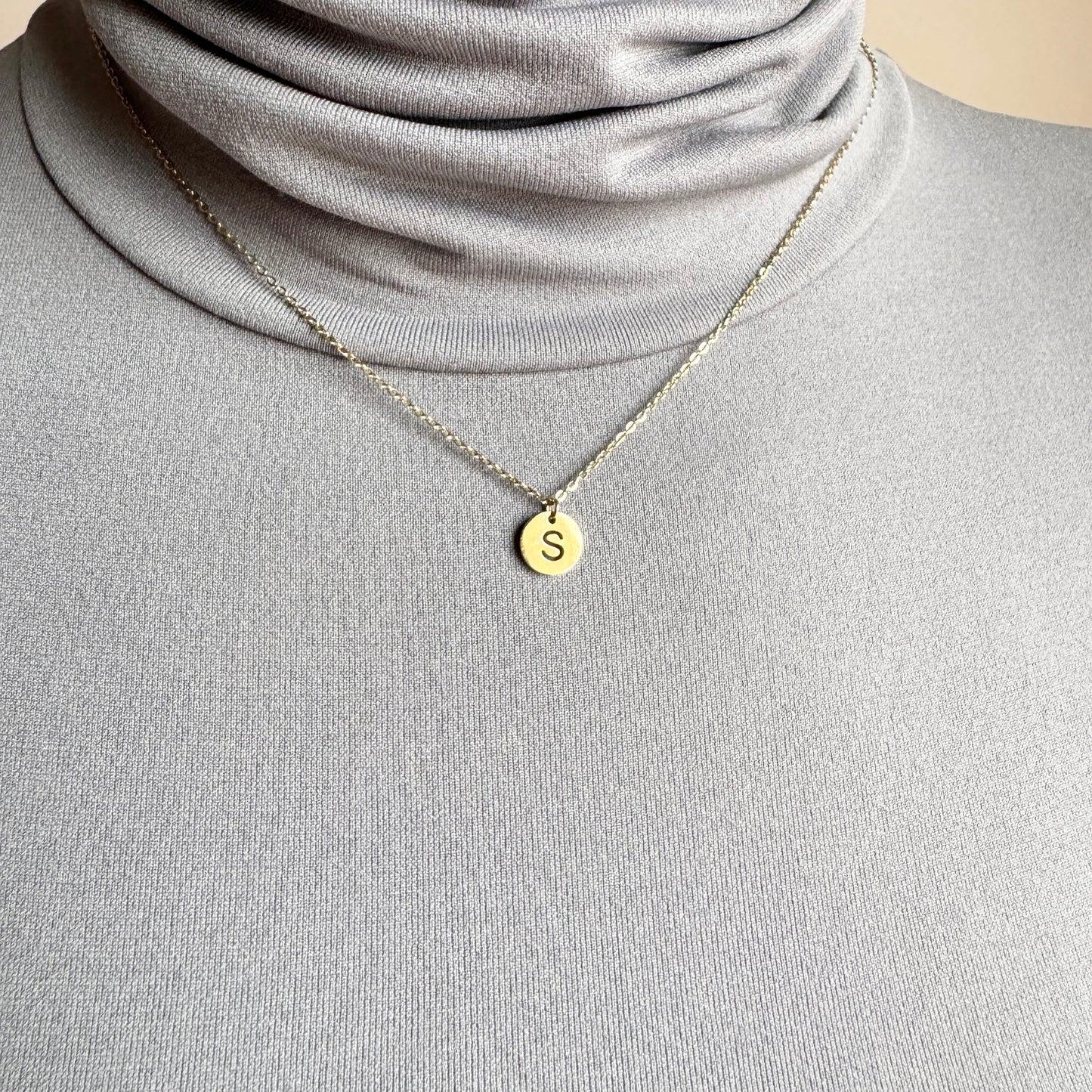 Letter S necklace IRL worn on the neck with a fine gold-tone chain