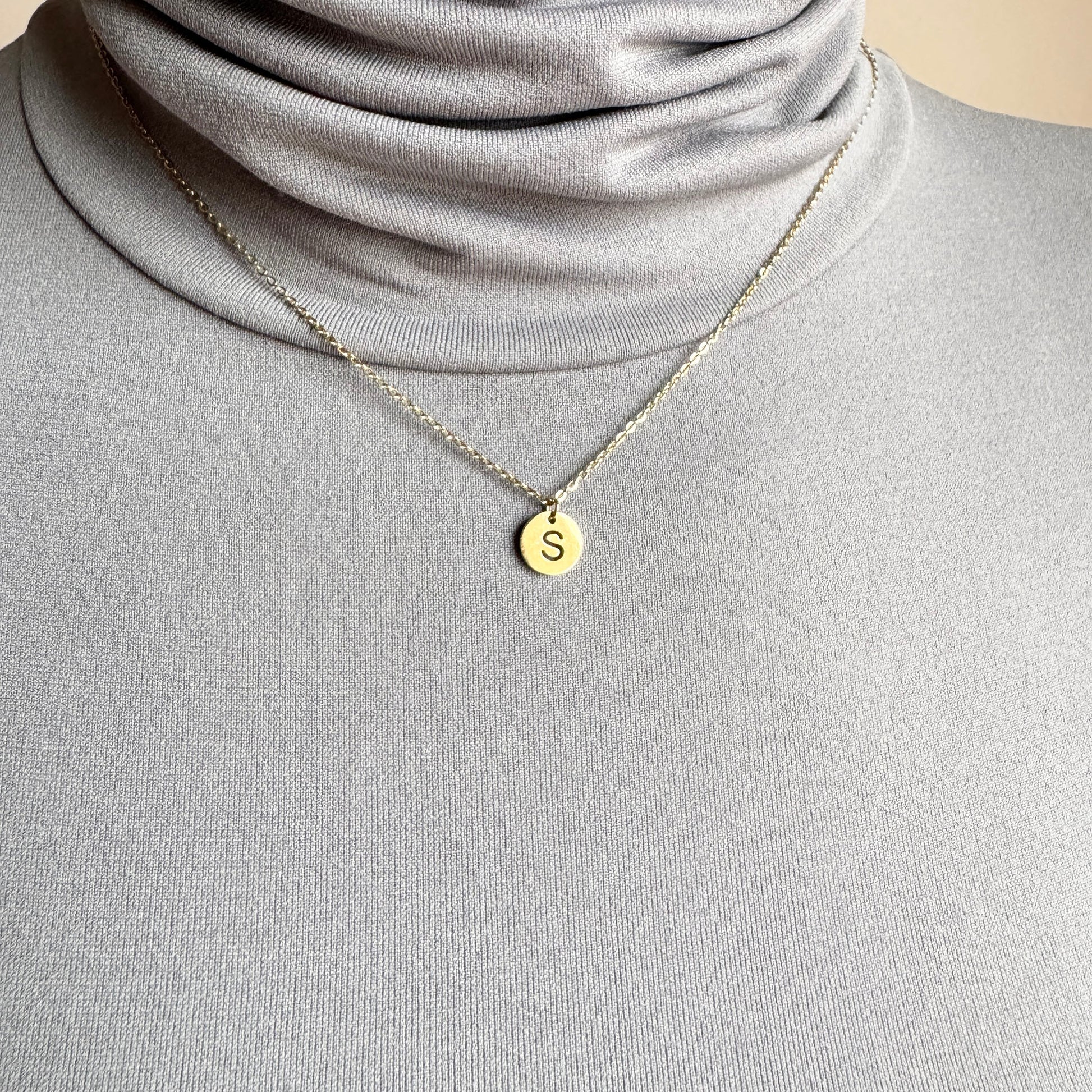 Letter S necklace IRL worn on the neck with a fine gold-tone chain