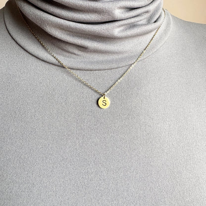 Letter S necklace IRL worn on the neck with a fine gold-tone chain