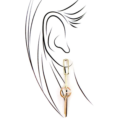 Long gold Cannelle earring styled on ear in elegant sketch