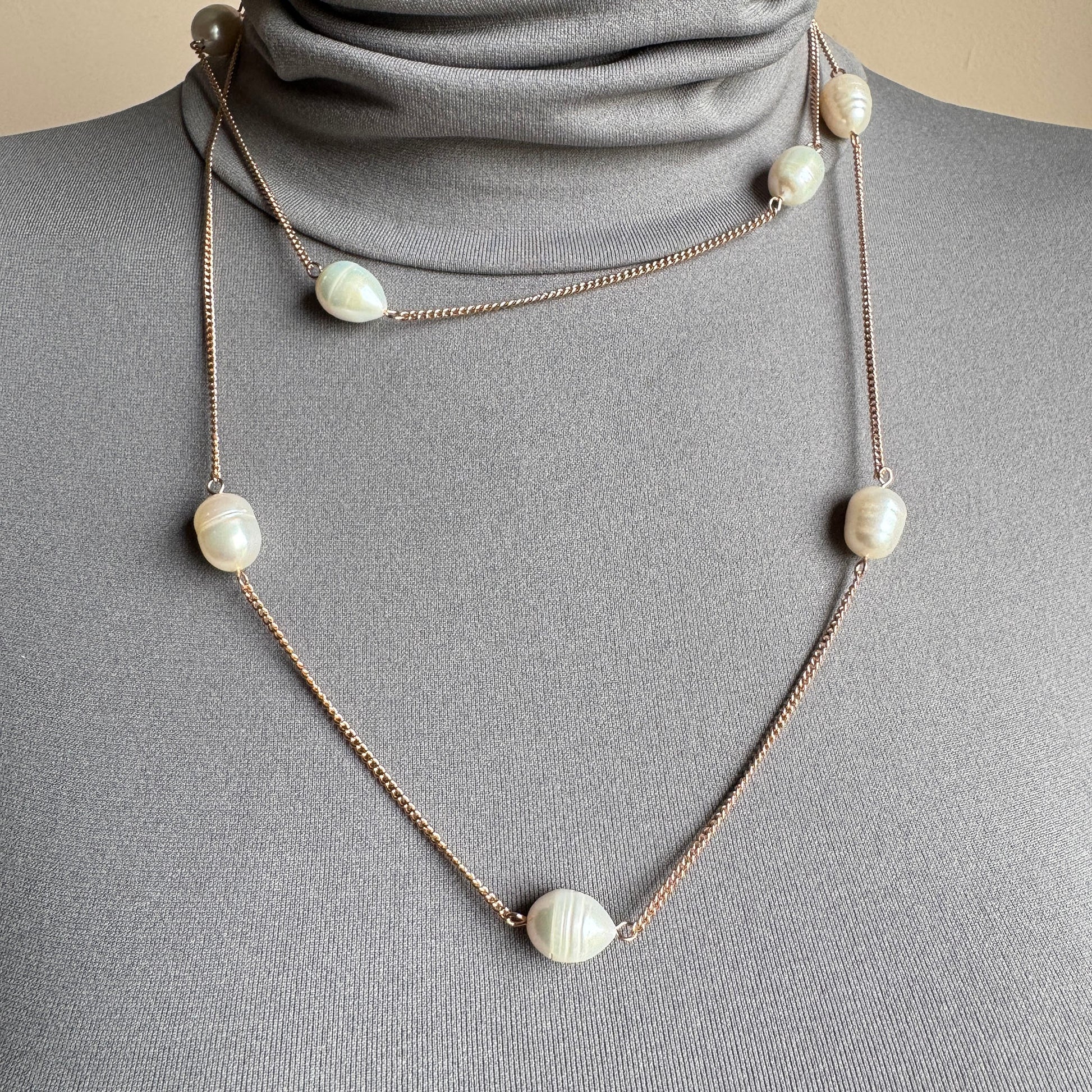 Long pearl necklace with irregular freshwater pearls worn single strand on a mannequin