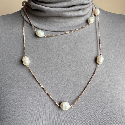 Long pearl necklace with irregular freshwater pearls worn single strand on a mannequin