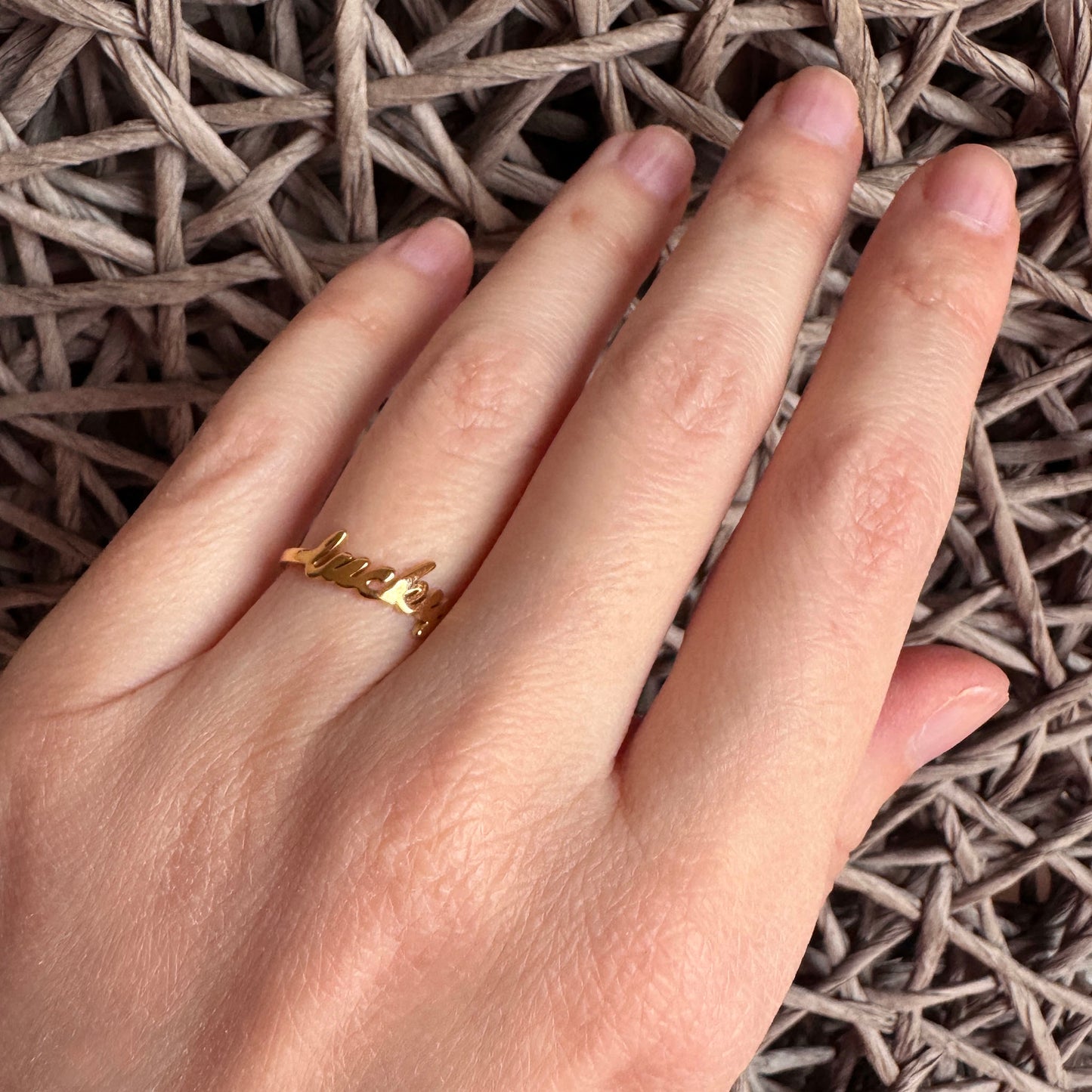 Lucky ring IRL worn on the hand with a delicate gold-tone finish
