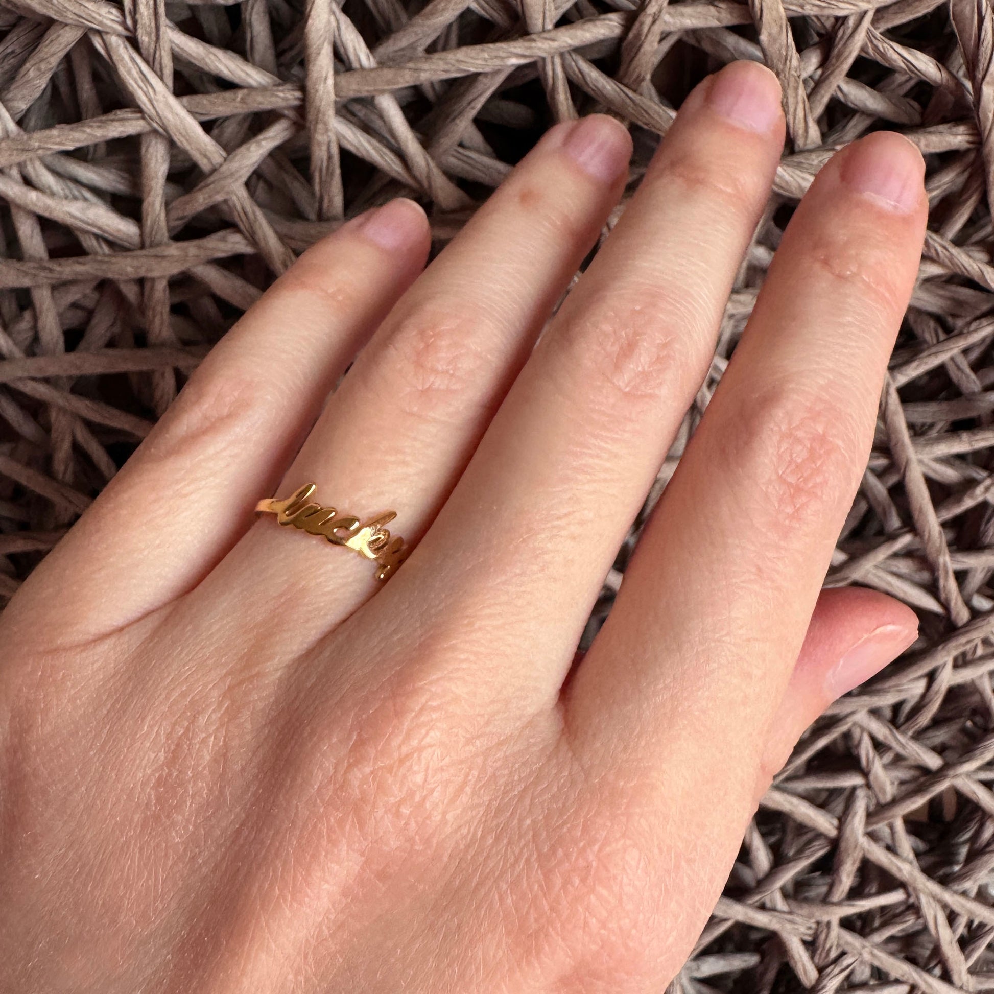Lucky ring IRL worn on the hand with a delicate gold-tone finish