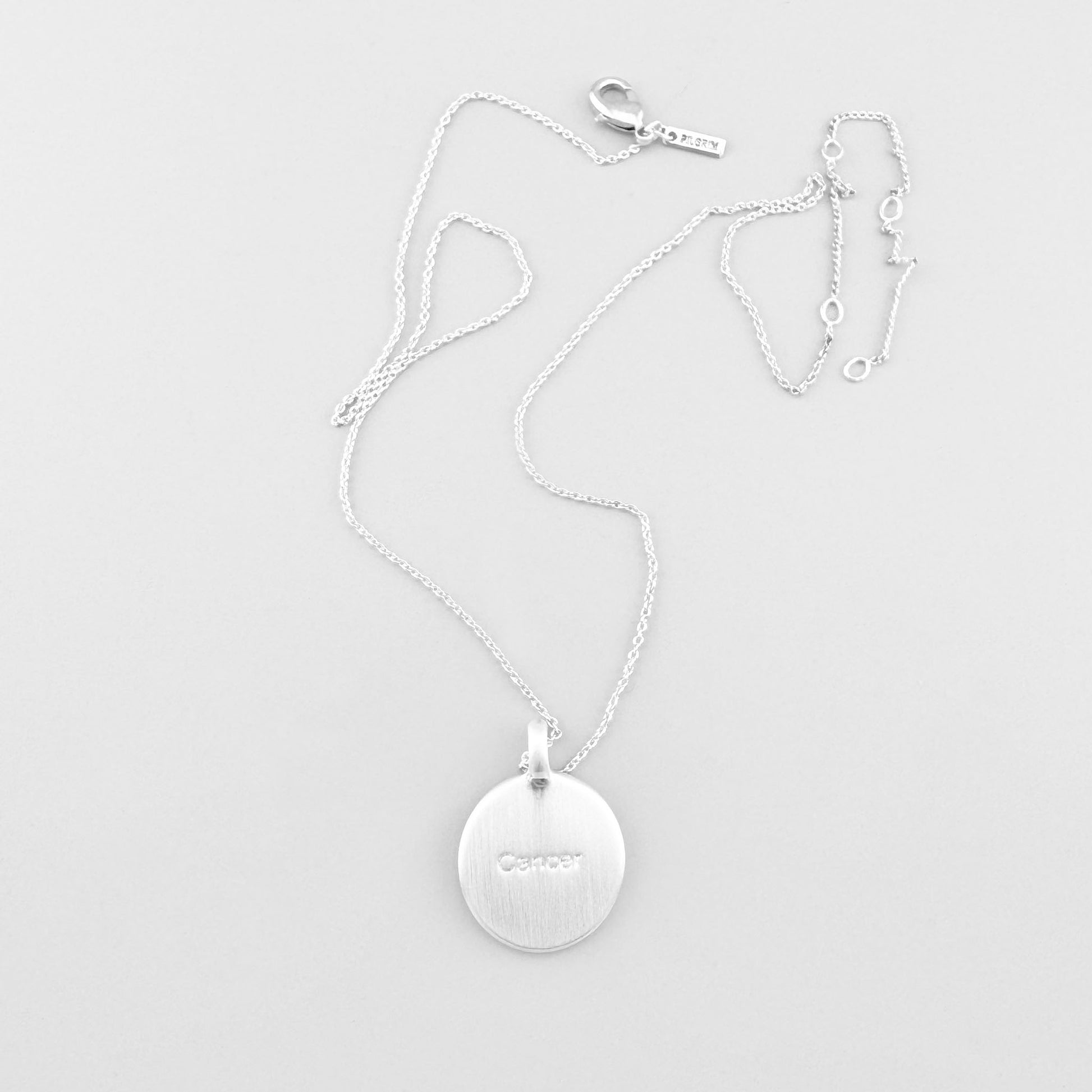 Pilgrim necklace with star-engraved round medallion displayed on light background
