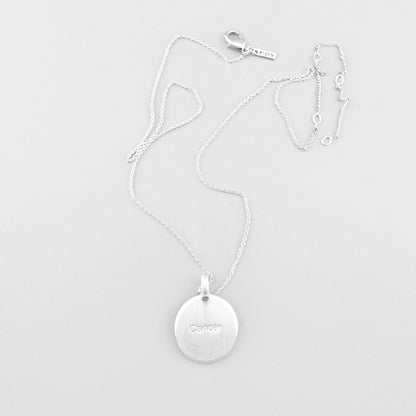 Pilgrim necklace with star-engraved round medallion displayed on light background