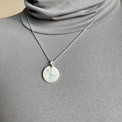 Pilgrim silver necklace with engraved star constellation medallion worn on neck