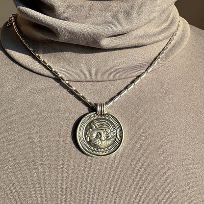 Pilgrim medallion necklace with geometric chain detail worn elegantly on neck