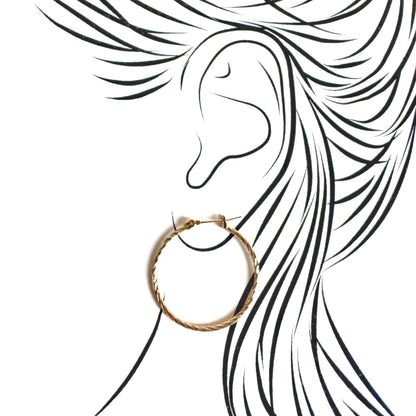 Medium gold hoops with twisted groove design and hinged clasp