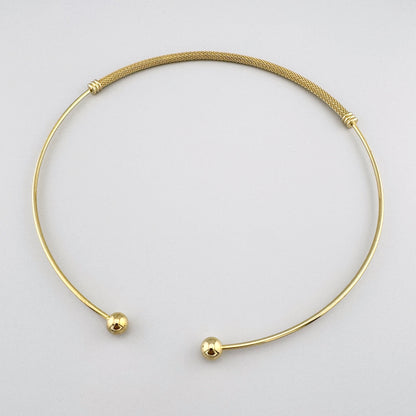 Elegant mesh jewelry set with open collar, cuff bracelet and hoops arranged in clean flatlay