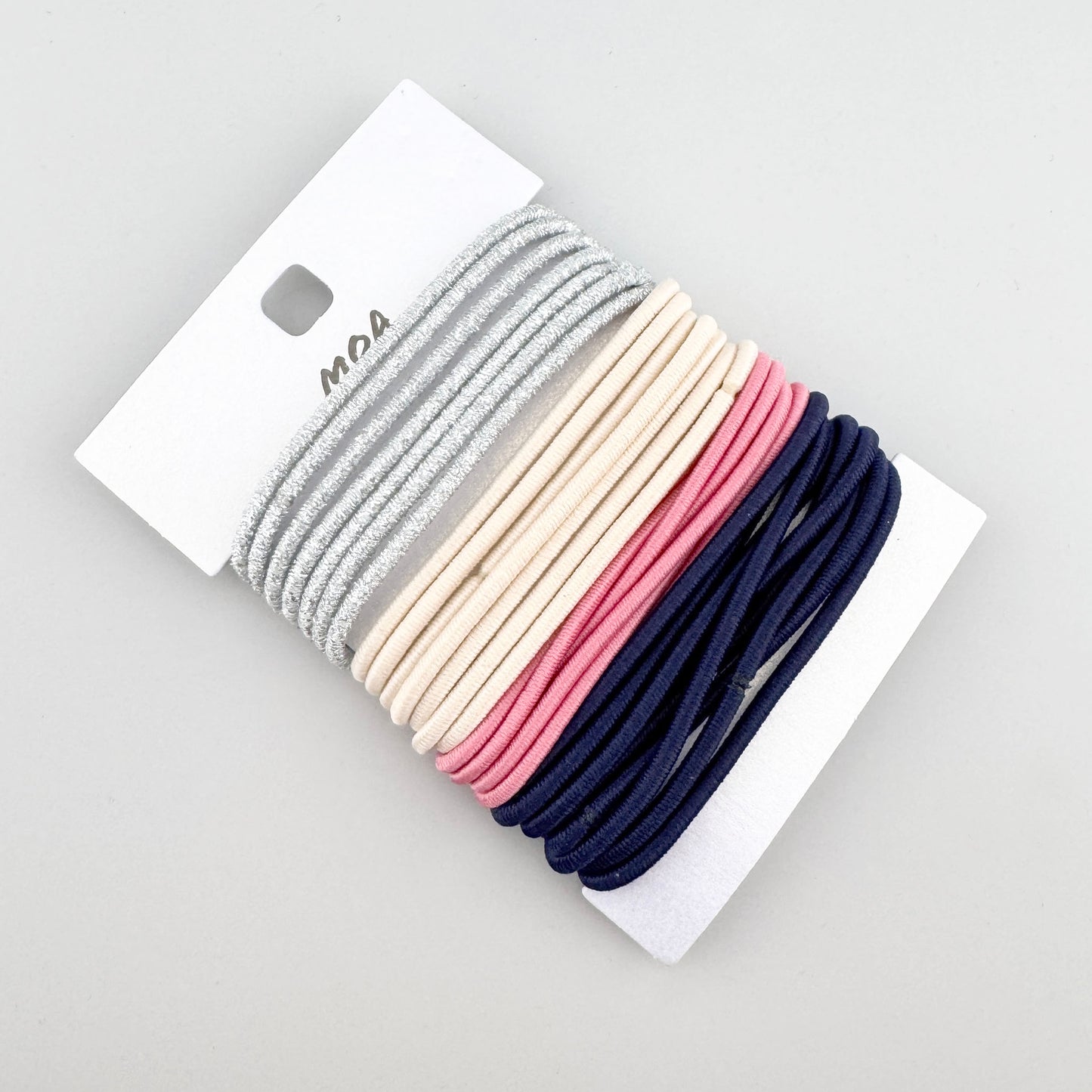 Moa hair ties set shown on a card in silver beige pink and navy tones