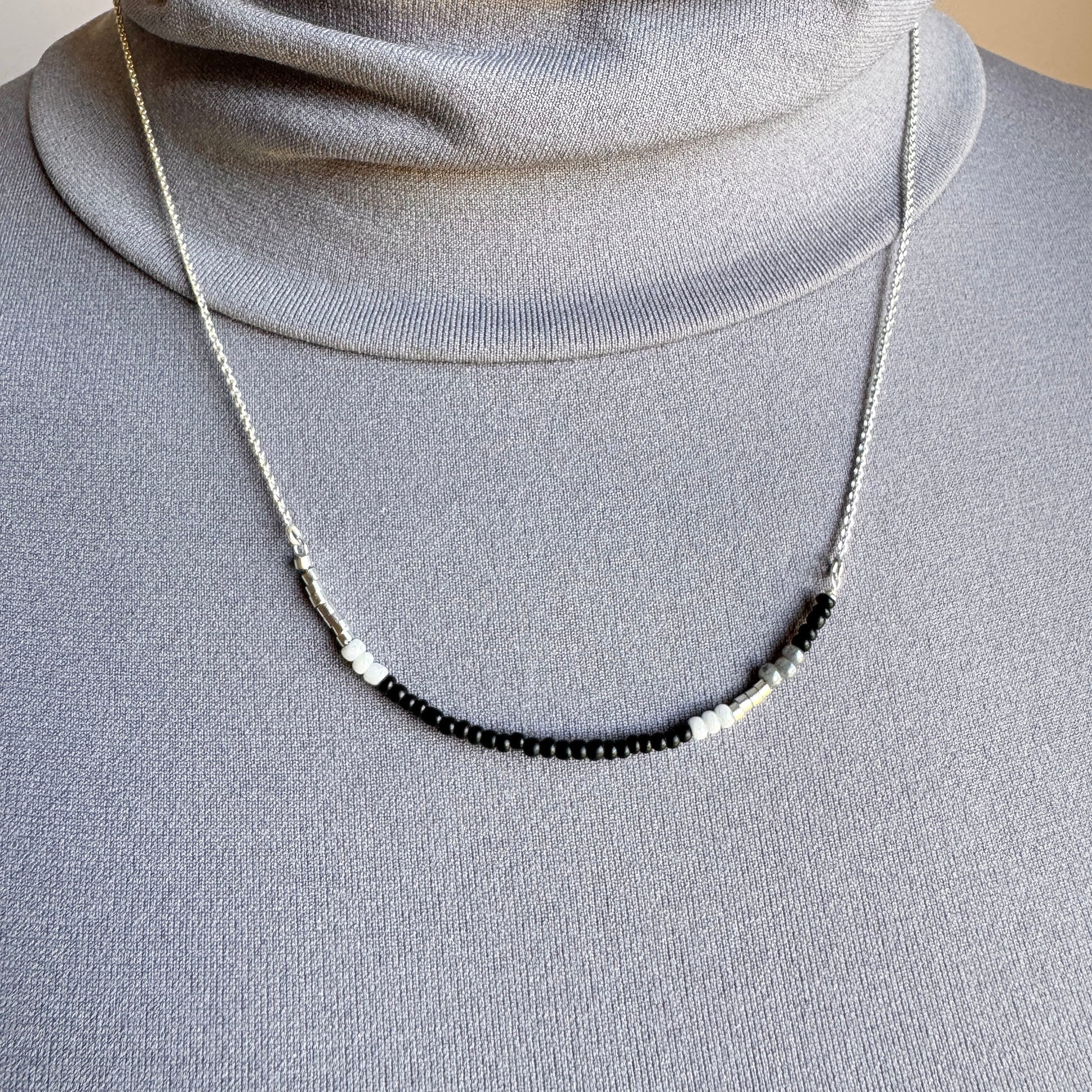 Sleek minimalist necklace with tiny contrast beads and polished chain