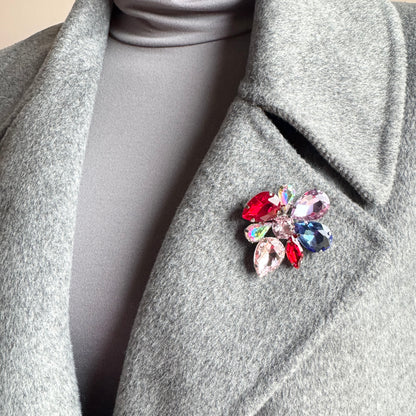Multicolor crystal flower brooch Sonata worn on a blazer with vivid faceted stones