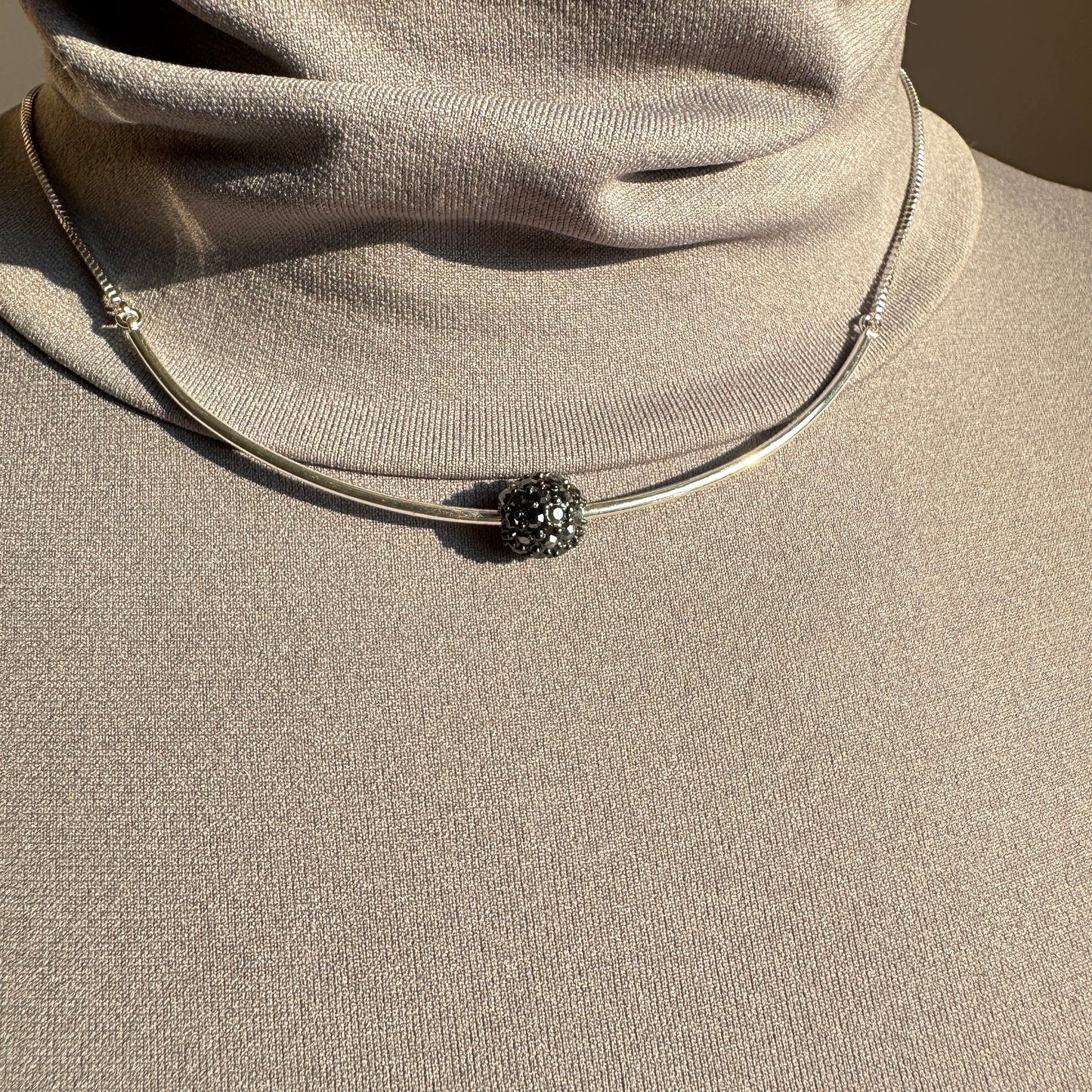 Pilgrim silver necklace with crystal-encrusted sphere worn on neck